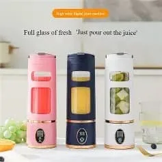 Three Juice Cup HP-880 portable blenders in pink, navy blue, and white displayed on a table