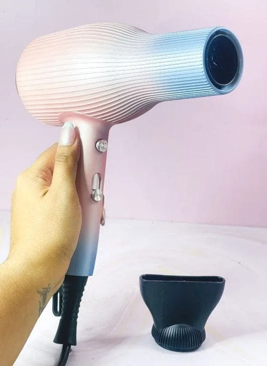 Person holding a pink and blue gradient GW professional hair dryer