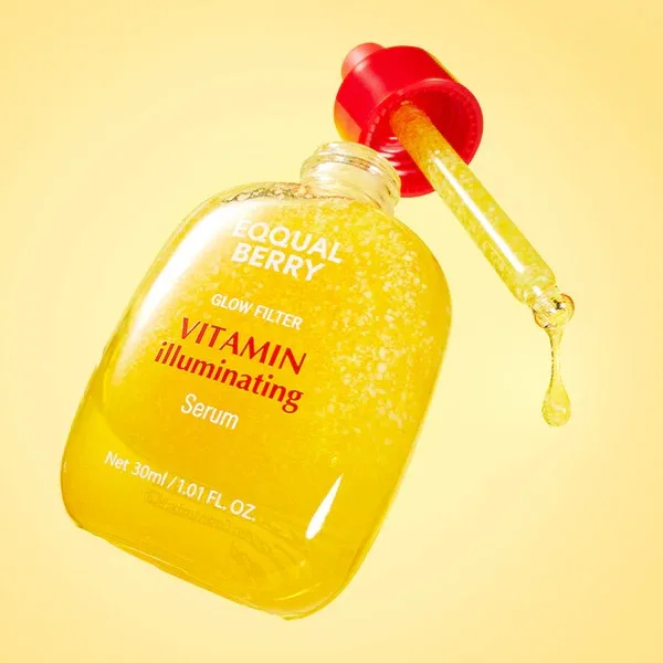 Close up of Eqqualberry Deep Cera Vitamin Illuminating Serum with a dropper dispensing the golden serum