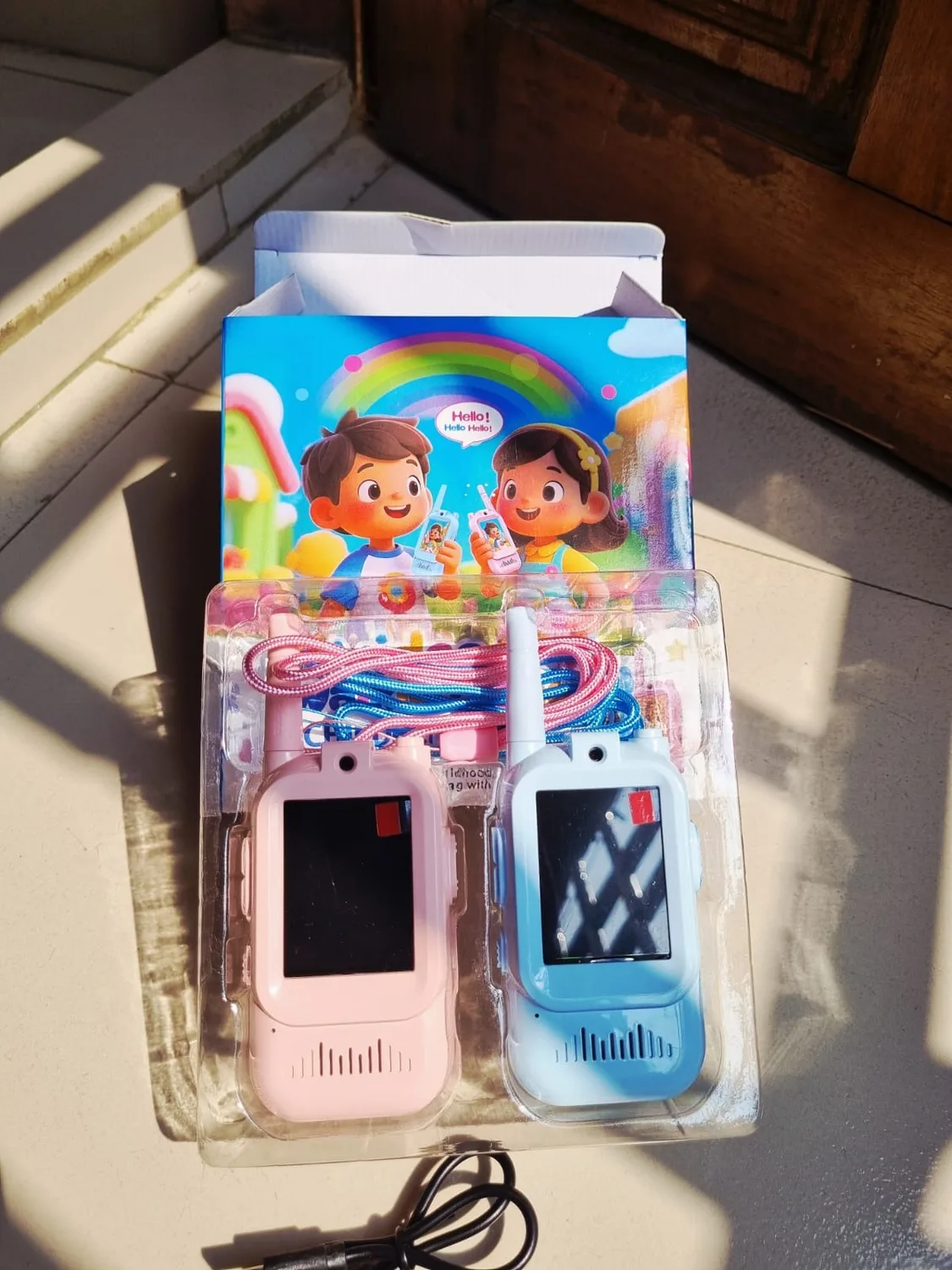 Unboxed Kids Video Calling Walkie-Talkie set with pink and blue devices and charging cable