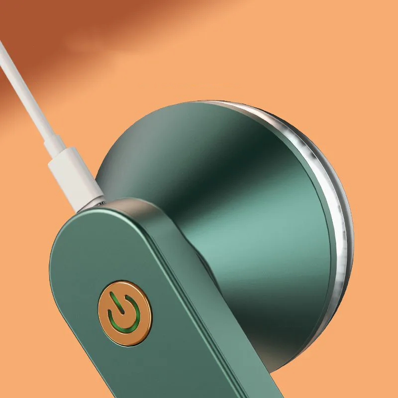 Close up of electric lint remover charging via USB cable