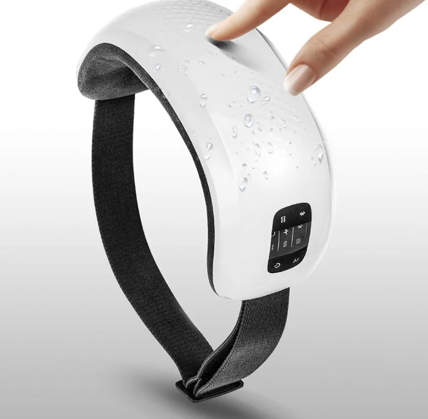 Close-up of white eye massager being touched to show surface texture and water resistance