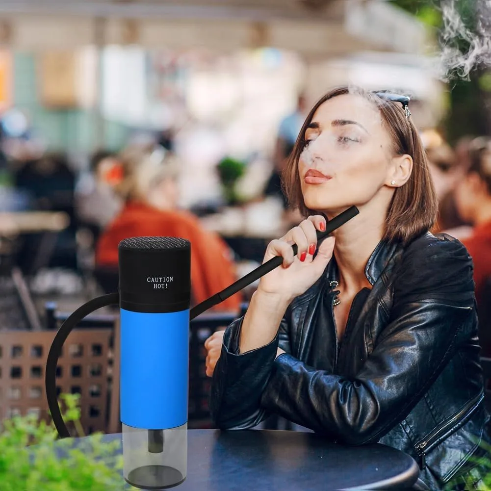 Woman smoking portable travel hookah at an outdoor cafe